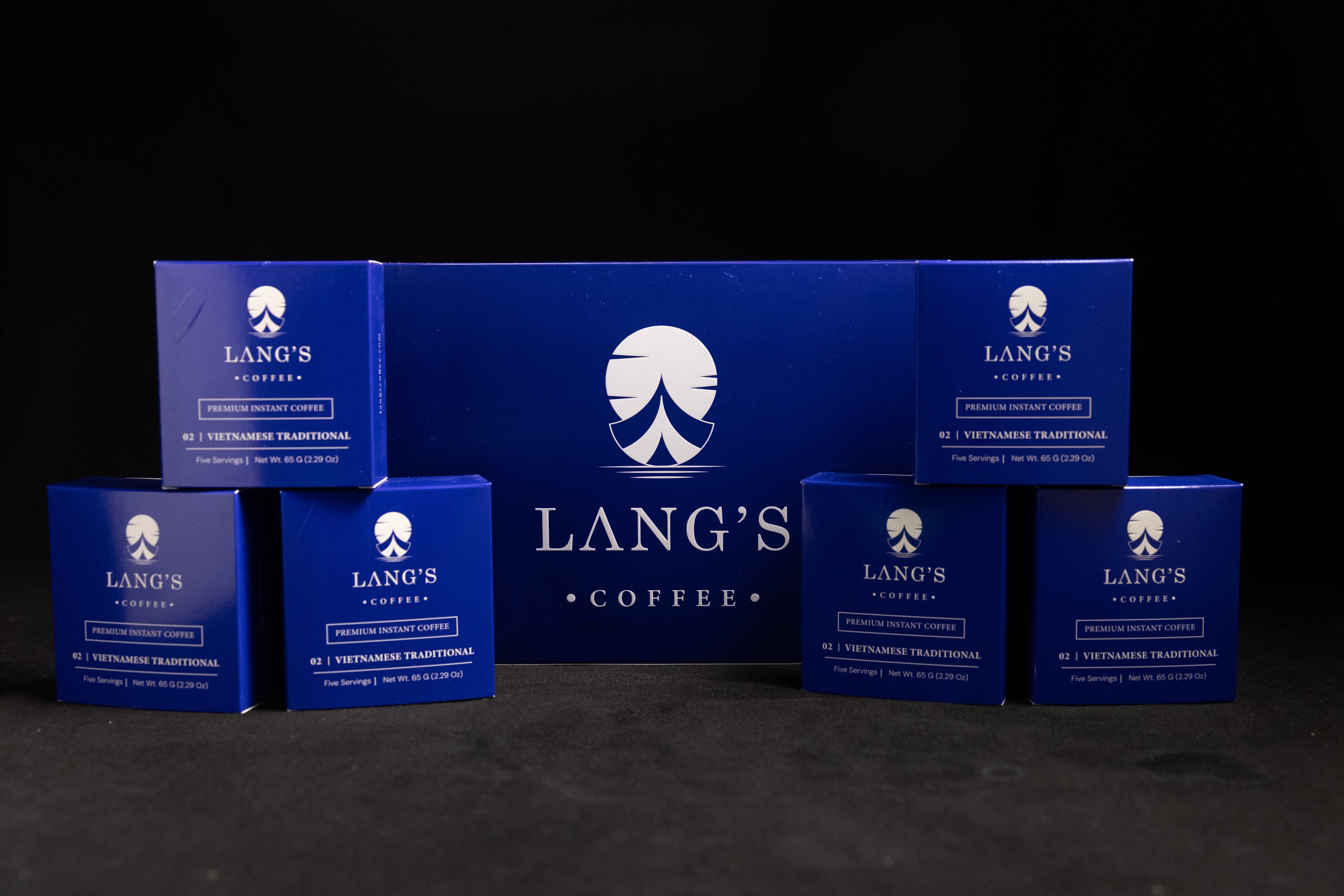 Collection of Lang's Coffee packages on a dark background